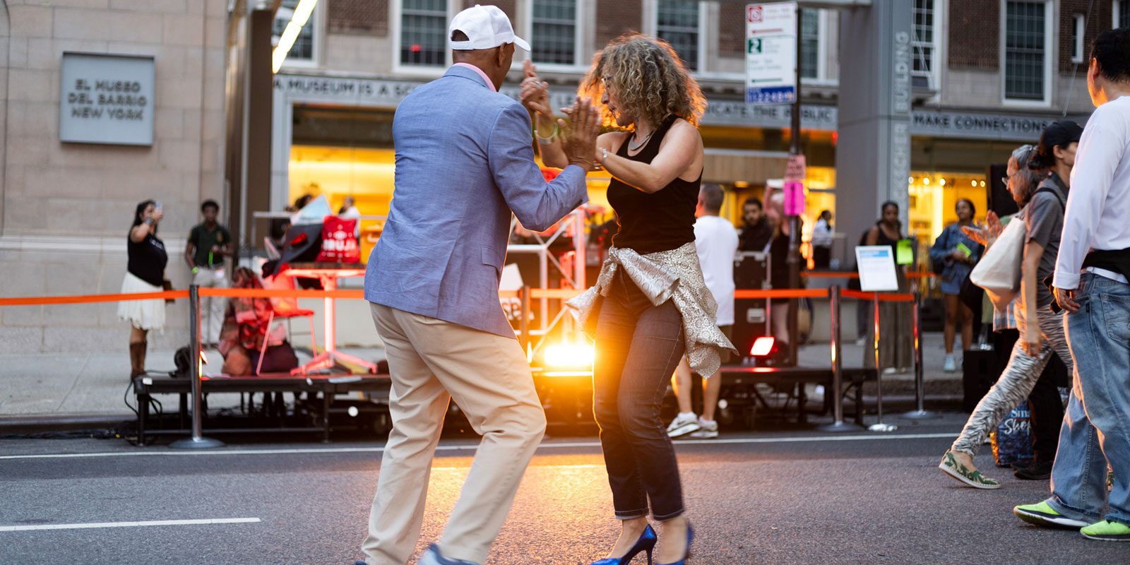 Couple dancing in the street in front of El Museo Entrance