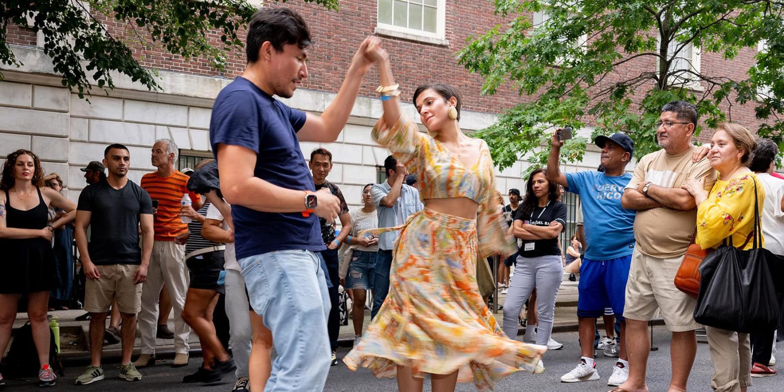 Two people dancing on the street